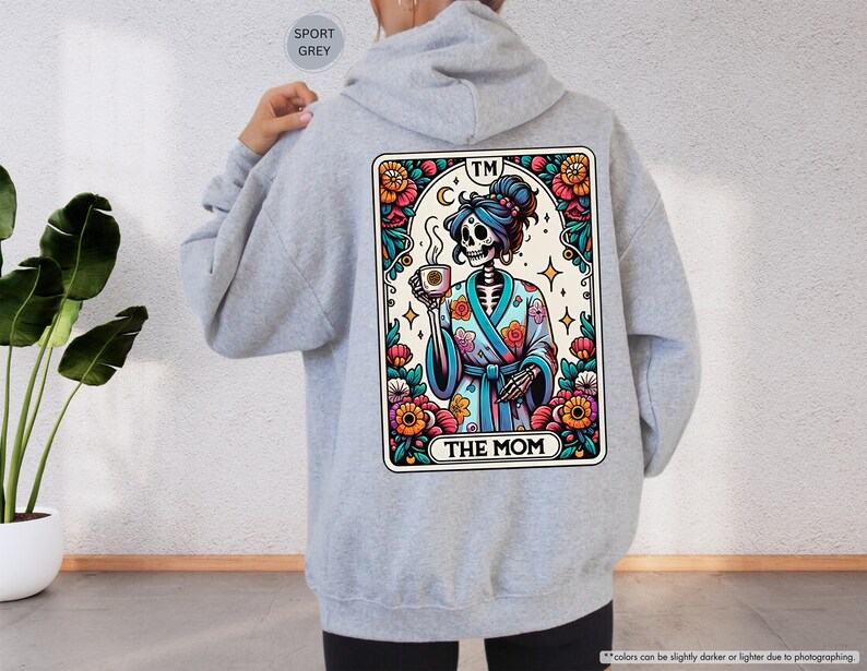 a person wearing a hoodie with a picture of a skeleton on it
