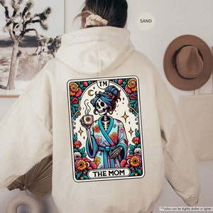 a person wearing a hoodie with a picture of a skeleton on it