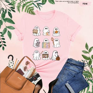 a pink t - shirt with ghost pictures on it