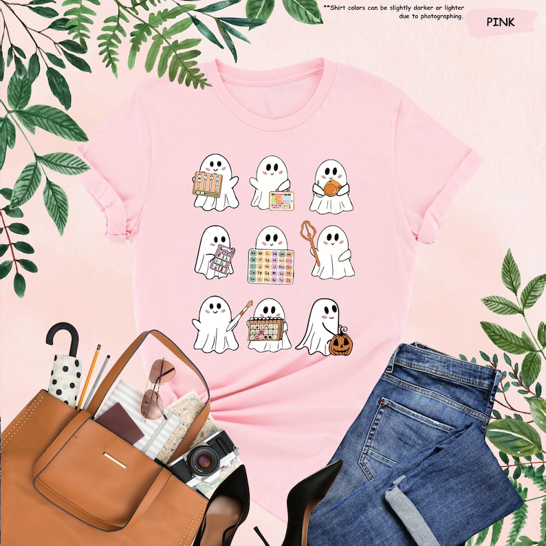 a pink t - shirt with ghost pictures on it