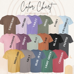 May include: A colour chart showing Comfort Colors t-shirts in various shades. The shirts are arranged to display colours such as Espresso, Orchid, Violet, Moss, Ivory, Chambray, Blossom, Berry, Bay, Yam, Black, Pepper, Mustard, Grey, Blue Jean, Light Green, and Crimson.