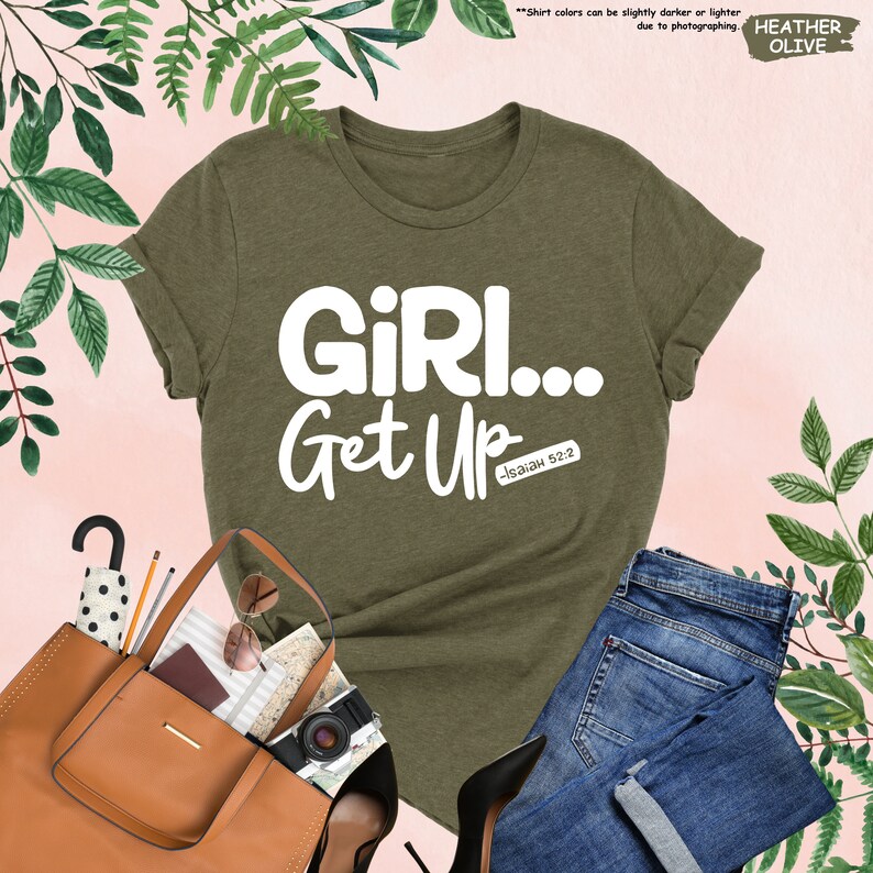 a t - shirt that says girl get up next to a handbag and purse