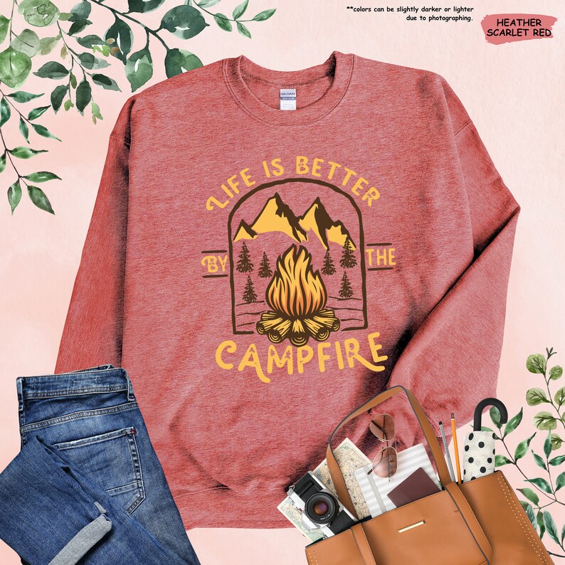 a red sweatshirt with a campfire graphic on it
