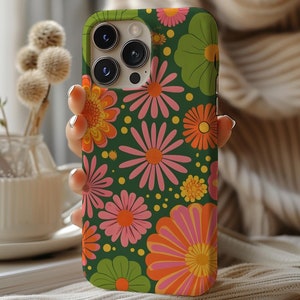 May include: A green phone case with a retro floral pattern featuring pink, orange, and green flowers. The case has a camera lens cutout.