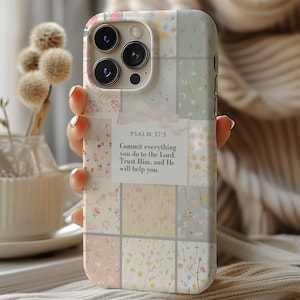 May include: A phone case with a floral pattern and a quote from Psalm 37:5, "Commit everything you do to the Lord. Trust Him, and He will help you."