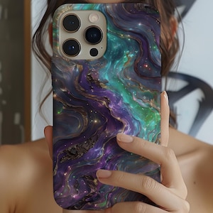 iPhone case with a stunning cosmic swirl design in vibrant purples, teals, and gold accents. The galaxy-inspired pattern blends flowing marble textures with a starry aesthetic, creating a bold and eye-catching phone accessory.