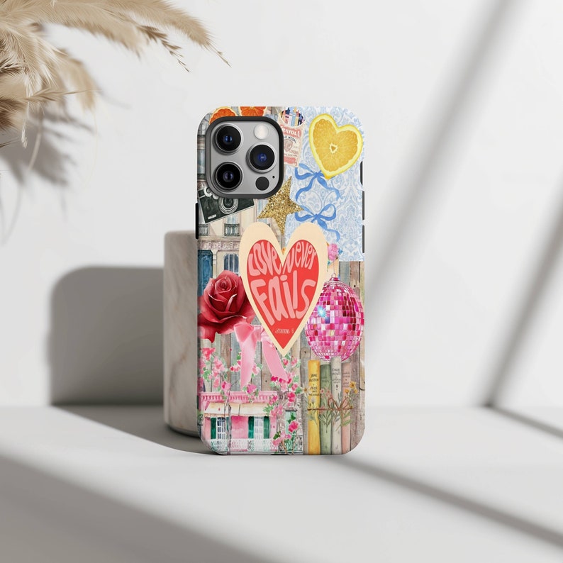 May include: A colorful phone case with a collage of images, including a heart with the text "Love never fails", a rose, a disco ball, and a lemon. The case is designed for an iPhone.