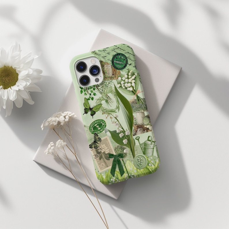 May include: A green phone case with a floral design featuring lilies of the valley, butterflies, and vintage stamps. The case has a light green background and a white border.
