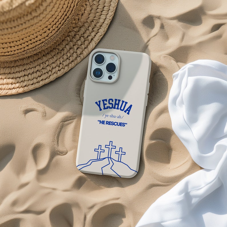 May include: A white phone case with a blue design. The design features the word "Yeshua" with the pronunciation "ye-shu-ah" and the phrase "He Rescues". Three crosses are depicted on a hill.