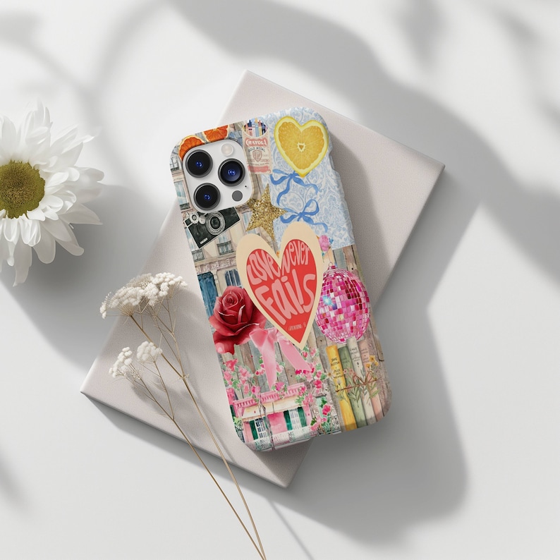 May include: A colorful phone case with a collage of images, including a heart with the text "Love never fails", a camera, a rose, and a disco ball.