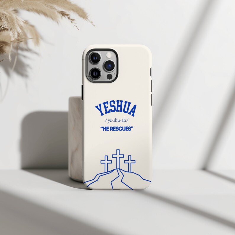 May include: White iPhone case with a blue graphic of three crosses on a hill. The text "YESHUA /ye-shu-ah/ "HE RESCUES" is printed on the case.
