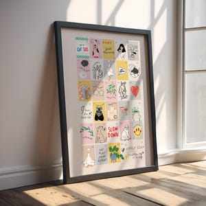 Puede incluir: Una impresión artística enmarcada con una cuadrícula de ilustraciones coloridas y texto. La obra de arte incluye imágenes de perros, corazones y tazas de café, junto con frases como "Good Morning" y "Slow Down". El nombre del artista, "EMILY BDAY", es visible.