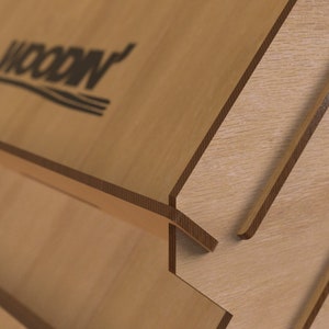 May include: A wooden display stand with a layered design. The top layer features the word "WOOD" in black lettering.