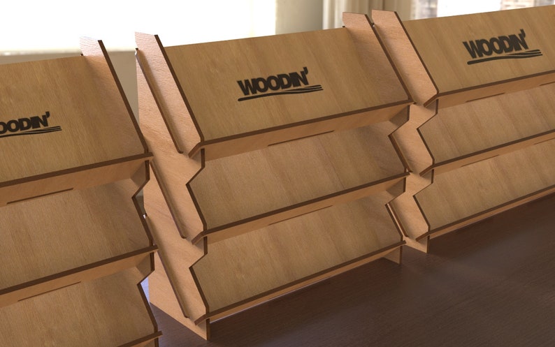 May include: A set of four wooden display stands with three shelves each. The stands are made of light brown wood and have a black "WOODN'" logo on the top shelf.