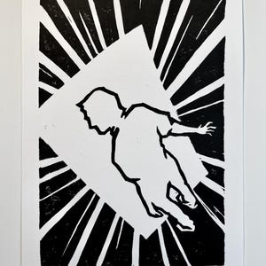 May include: A black and white linocut print on paper featuring the silhouette of a person in a dynamic, floating pose. The figure is centered within a white rectangular frame, surrounded by bold, radiating black lines that create a high-contrast effect.
