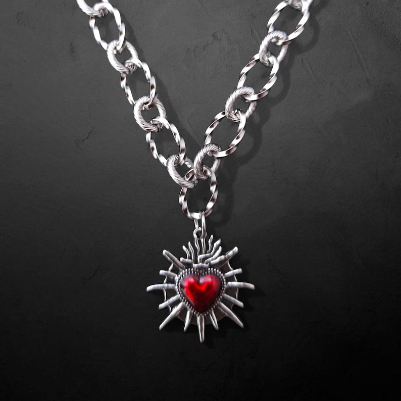 Our Thorn Heart Necklace, a stunning gothic necklace crafted with care and precision. This goth chain necklace features a striking black or red heart pendant wrapped in intricate thorn details, perfectly embodying alternative and edgy style.
Measuring approximately 16 inches in length with an Magnetic clasp. The pendant itself is compact yet bold, making a unique statement piece that enhances any gothic or punk-inspired outfit.
