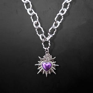 Our Thorn Heart Necklace, a stunning gothic necklace crafted with care and precision. This goth chain necklace features a striking black or red heart pendant wrapped in intricate thorn details, perfectly embodying alternative and edgy style.
Measuring approximately 16 inches in length with an Magnetic clasp. The pendant itself is compact yet bold, making a unique statement piece that enhances any gothic or punk-inspired outfit.