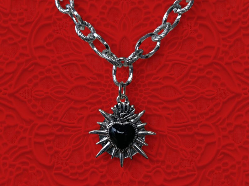 Our Thorn Heart Necklace, a stunning gothic necklace crafted with care and precision. This goth chain necklace features a striking black or red heart pendant wrapped in intricate thorn details, perfectly embodying alternative and edgy style.
Measuring approximately 16 inches in length with an Magnetic clasp. The pendant itself is compact yet bold, making a unique statement piece that enhances any gothic or punk-inspired outfit.