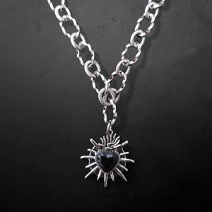Our Thorn Heart Necklace, a stunning gothic necklace crafted with care and precision. This goth chain necklace features a striking black or red heart pendant wrapped in intricate thorn details, perfectly embodying alternative and edgy style.
Measuring approximately 16 inches in length with an Magnetic clasp. The pendant itself is compact yet bold, making a unique statement piece that enhances any gothic or punk-inspired outfit.