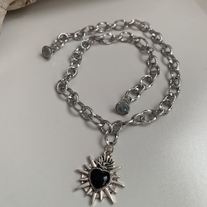 Our Thorn Heart Necklace, a stunning gothic necklace crafted with care and precision. This goth chain necklace features a striking black or red heart pendant wrapped in intricate thorn details, perfectly embodying alternative and edgy style.
Measuring approximately 16 inches in length with an Magnetic clasp. The pendant itself is compact yet bold, making a unique statement piece that enhances any gothic or punk-inspired outfit.