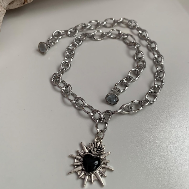 Our Thorn Heart Necklace, a stunning gothic necklace crafted with care and precision. This goth chain necklace features a striking black or red heart pendant wrapped in intricate thorn details, perfectly embodying alternative and edgy style.
Measuring approximately 16 inches in length with an Magnetic clasp. The pendant itself is compact yet bold, making a unique statement piece that enhances any gothic or punk-inspired outfit.