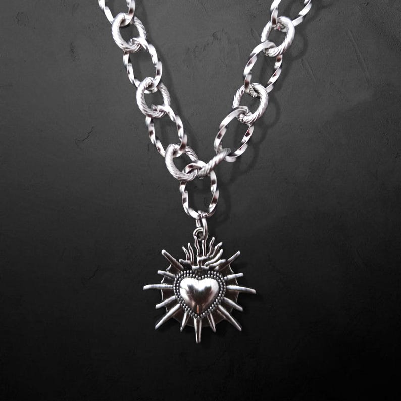 Our Thorn Heart Necklace, a stunning gothic necklace crafted with care and precision. This goth chain necklace features a striking black or red heart pendant wrapped in intricate thorn details, perfectly embodying alternative and edgy style.
Measuring approximately 16 inches in length with an Magnetic clasp. The pendant itself is compact yet bold, making a unique statement piece that enhances any gothic or punk-inspired outfit.