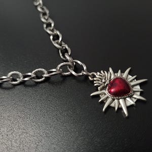 Our Thorn Heart Necklace, a stunning gothic necklace crafted with care and precision. This goth chain necklace features a striking black or red heart pendant wrapped in intricate thorn details, perfectly embodying alternative and edgy style.
Measuring approximately 16 inches in length with an Magnetic clasp. The pendant itself is compact yet bold, making a unique statement piece that enhances any gothic or punk-inspired outfit.