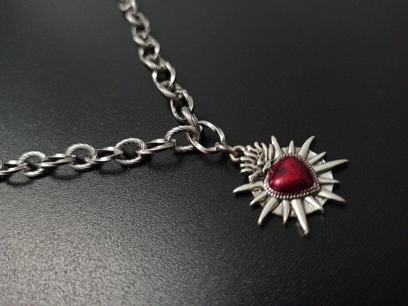 Our Thorn Heart Necklace, a stunning gothic necklace crafted with care and precision. This goth chain necklace features a striking black or red heart pendant wrapped in intricate thorn details, perfectly embodying alternative and edgy style.
Measuring approximately 16 inches in length with an Magnetic clasp. The pendant itself is compact yet bold, making a unique statement piece that enhances any gothic or punk-inspired outfit.