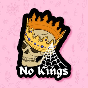 May include: A sticker featuring a skull wearing a gold crown with blue jewels, and a white spiderweb. The words "No Kings" are written in a bold, white font with a black outline. The sticker has a black border and is set against a pink background.