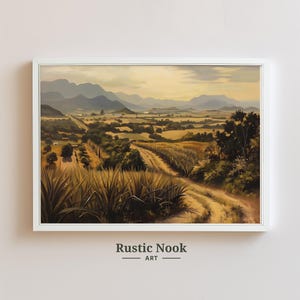 May include: A painting depicting a rural landscape with a dirt track winding through a field of agave plants. The track leads to a distant mountain range under a cloudy sky. The painting has a warm, golden colour palette.