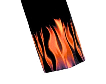 May include: Black fabric with a flame pattern in orange and yellow.