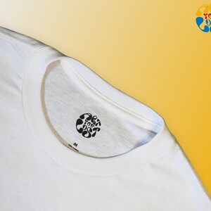 May include: White t-shirt with a black circular logo that says "Get You Lost" in a stylized font. The shirt has a size tag that says "M".