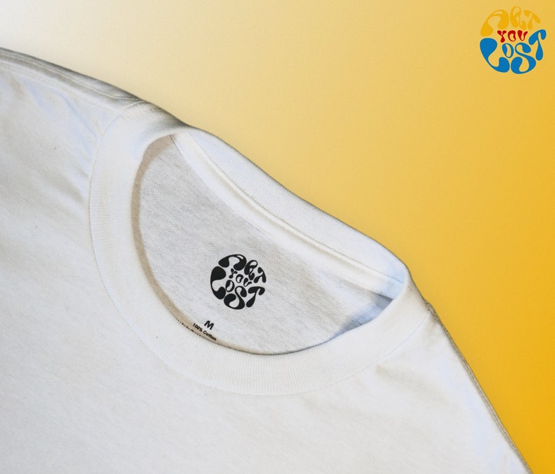 May include: White t-shirt with a black circular logo that says "Get You Lost" in a stylized font. The shirt has a size tag that says "M".