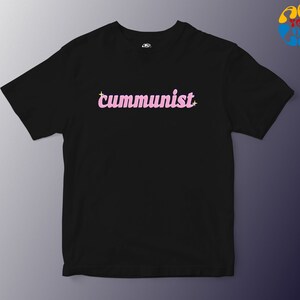 May include: Black t-shirt with the word "communist" in pink letters with a sparkle on each side.