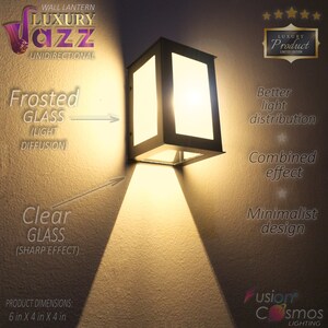 May include: A black wall lantern with a frosted glass panel and a clear glass panel. The lantern is mounted on a wall and is casting a warm light. The text "LUXURY Product LIMITED EDITION" is visible in the top right corner of the image. The text "WALL LANTERN LUXURY Jazz UNIDIRECTIONAL" is visible in the top left corner of the image. The text "Frosted GLASS (LIGHT DIFFUSION)" is visible in the bottom left corner of the image. The text "Clear GLASS (SHARP EFFECT)" is visible in the bottom left corner of the image. The text "PRODUCT DIMENSIONS: 6 in X 4 in X 4 in" is visible in the bottom left corner of the image. The text "Better light distribution" is visible in the top right corner of the image. The text "Combined effect" is visible in the bottom right corner of the image. The text "Minimalist design" is visible in the bottom right corner of the image. The text "fusion Cosmos LIGHTING" is visible in the bottom right corner of the image.