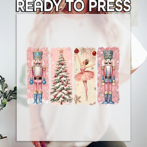 May include: A pink and white sublimation design featuring a ballerina, a Christmas tree, and two nutcracker soldiers. The design is ready to be pressed onto a t-shirt or other fabric.