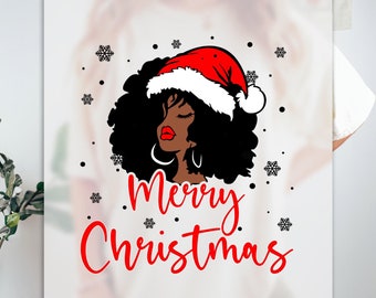 May include: A white t-shirt with a red "Merry Christmas" text and a black and red illustration of a woman with afro hair wearing a Santa hat. The background has a snowflake pattern.