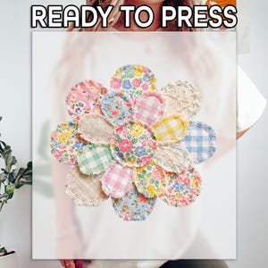 May include: A floral design with a variety of fabric patterns, including floral, gingham, and lace, arranged in a flower shape. The text "READY TO PRESS" is at the top. The design is on a white background.