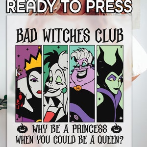 May include: A white graphic featuring the text "READY TO PRESS" at the top. Below, the words "BAD WITCHES CLUB" are displayed above four cartoon portraits. The phrase "WHY BE A PRINCESS WHEN YOU COULD BE A QUEEN?" is at the bottom, with pumpkin graphics on each side.