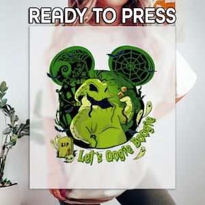May include: White t-shirt with a green Oogie Boogie design. The design features a green Oogie Boogie character, bats, a haunted house, and the text "Let's Oogie Boogie". The words "READY TO PRESS" are at the top.
