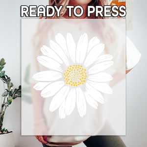 May include: A white t-shirt with a white daisy graphic. The text "READY TO PRESS" is printed in black at the top of the image.