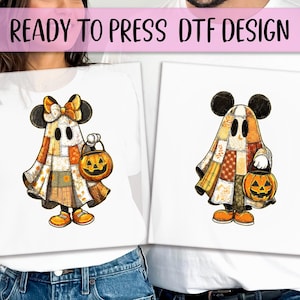 May include: White t-shirts with a Halloween-themed design. The design features a cartoon ghost character with Mickey Mouse ears, holding a jack-o'-lantern. The ghost is made of patchwork fabric in shades of orange, brown, and white. Text at the top reads "READY TO PRESS DTF DESIGN."
