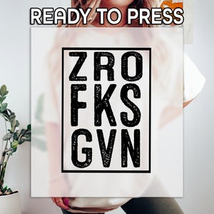 May include: White t-shirt with a black square graphic that says "ZRO FKS GVN".
