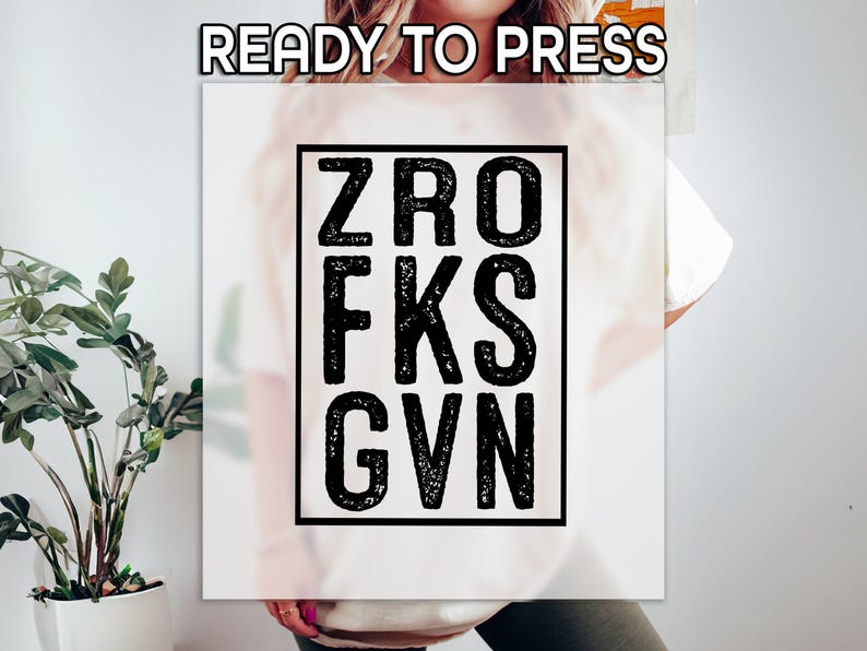 May include: White t-shirt with a black square graphic that says "ZRO FKS GVN".