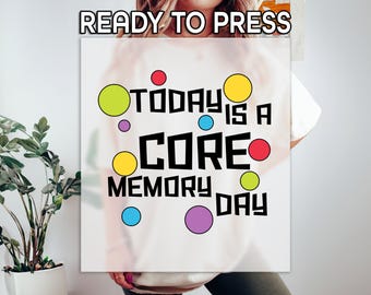 May include: White t-shirt with the text "TODAY IS A CORE MEMORY DAY" in black letters with colorful circles around the text.