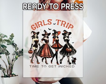 May include: A white graphic featuring four women dressed as witches, each holding a pumpkin. The text "GIRLS TRIP" and "TIME TO GET WICKED" are in orange. The image is labeled "READY TO PRESS" at the top.