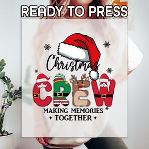 May include: A white graphic featuring the words "READY TO PRESS" at the top. Below, the word "Christmas" is written in black script, with the word "CREW" spelled out in festive letters. The letters are designed as Santa, an elf, and a reindeer. The phrase "MAKING MEMORIES + TOGETHER +" is below.