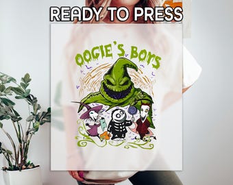 May include: White t-shirt featuring a green Oogie Boogie character with the text "Oogie's Boys." Below the character are three smaller figures. The words "READY TO PRESS" are at the top. The design is in green, purple, black, and white.