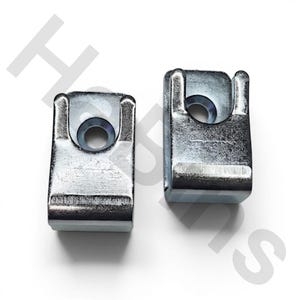 May include: Two rectangular silver-colored metal mounting brackets with a smooth, reflective finish. Each bracket features a U-shaped cutout at the top and a single circular hole centered below the cutout for secure attachment or fastening purposes.
