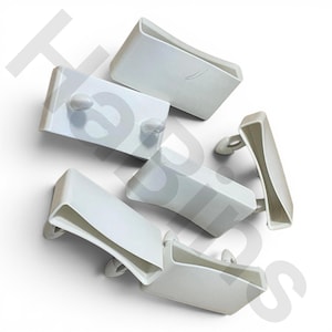 May include: A collection of white plastic clips, each with a rectangular body and a curved, open-ended design. Some clips have small, rounded protrusions. The clips are arranged on a white background.